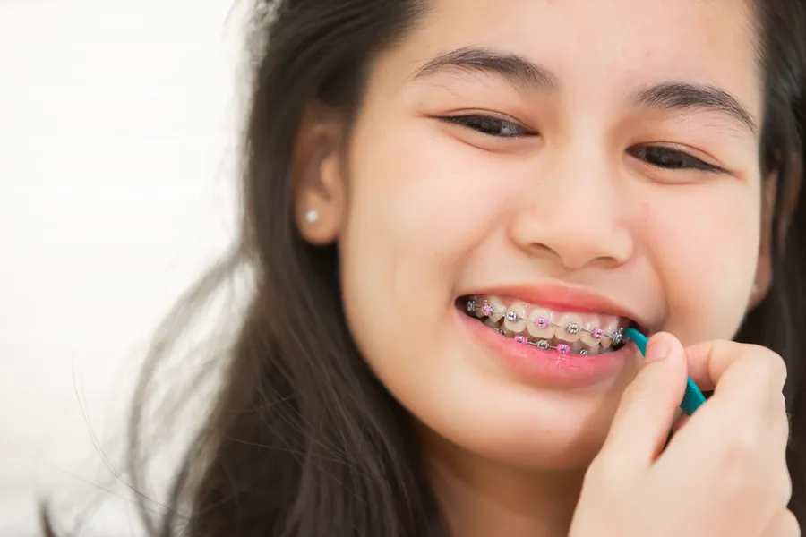 Orthodontist adjusting a child's braces