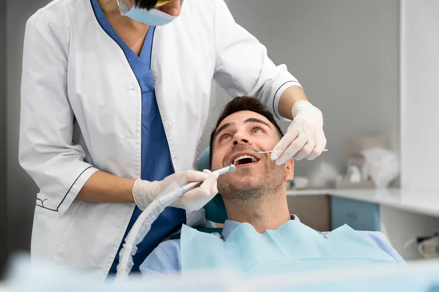Hygienist cleaning a patient's teeth