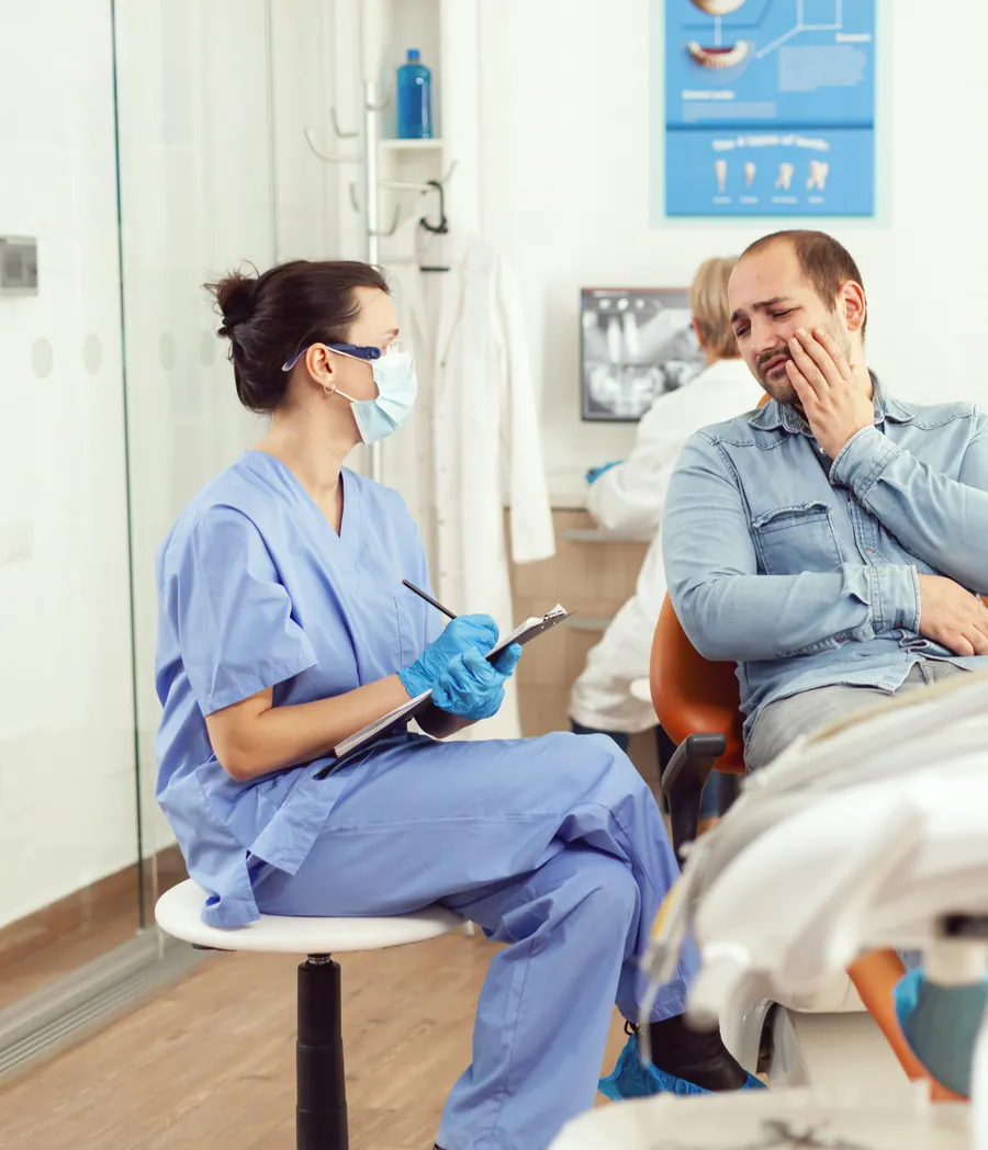 Patient holding their jaw with tooth pain