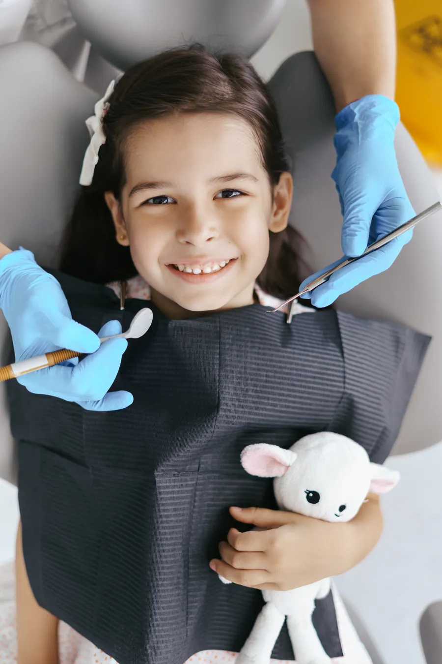 Dentist showing a child how to brush