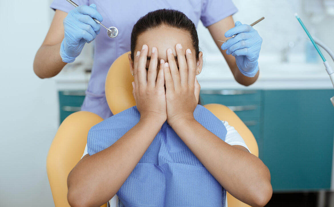 Fear, horror and fright expresses little girl in dental clinic