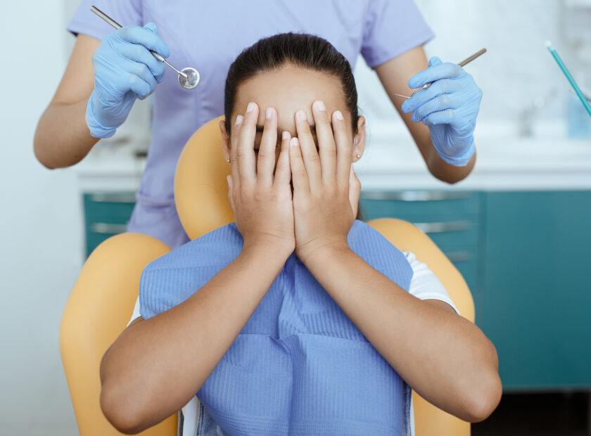 Fear, horror and fright expresses little girl in dental clinic